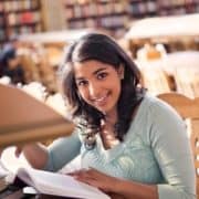 teenager smiling in libarary