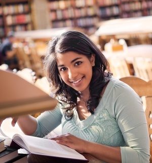 teenager smiling in libarary