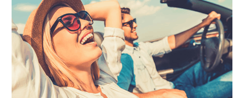 couple driving convertable