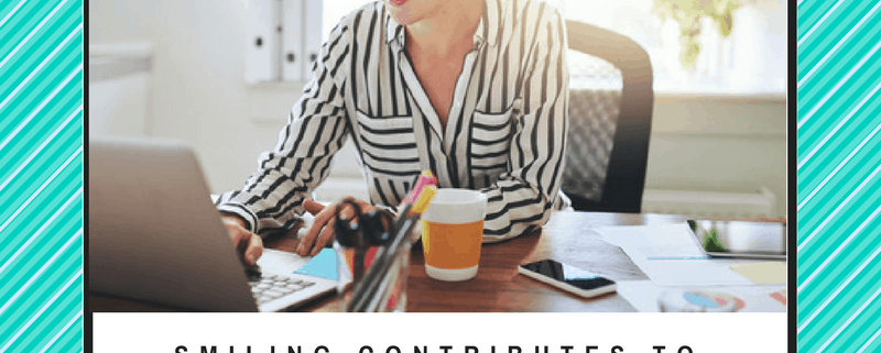 woman smiling at desk