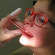 child wearing red glasses